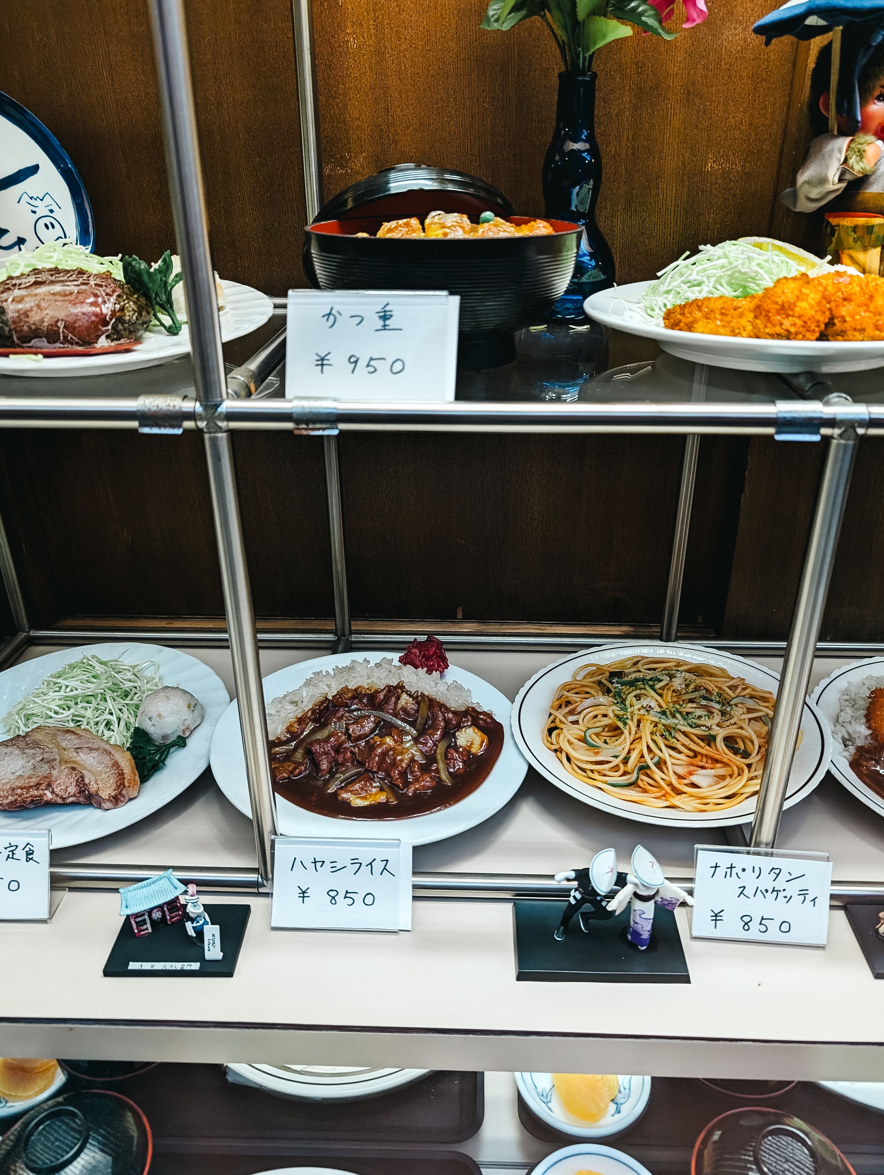 Authentic Japanese meals displayed with price tags in a Tokyo restaurant.