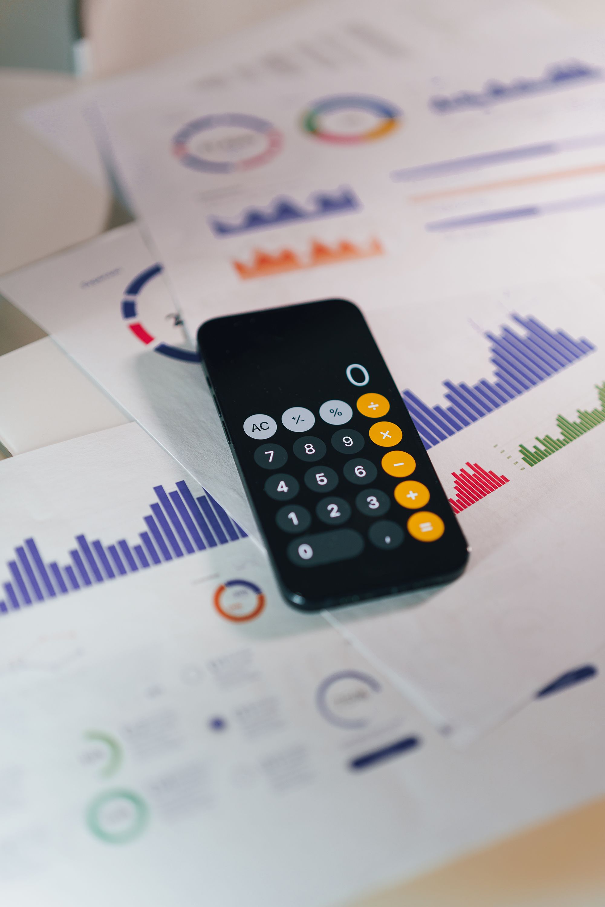 Calculator on graphs showing financial data and analytics. Ideal for business and finance themes.